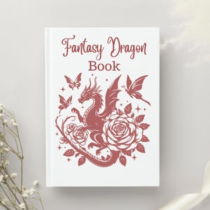 Puede incluir: Un libro blanco con el texto "Fantasy Dragon Book" en letras rojas. La portada presenta una silueta roja de un drag&oacute;n con las alas extendidas, rodeado de rosas y mariposas.