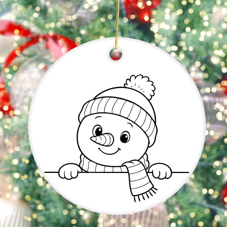 May include: A white, round Christmas ornament featuring a black and white illustration of a snowman. The snowman wears a knit hat, scarf, and has a carrot nose. The ornament is hanging by a gold string.