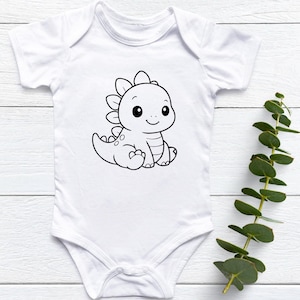 May include: White baby onesie featuring a black and white cartoon dinosaur illustration. The dinosaur is sitting with a smiling face and spiky back. The onesie is made of soft material and has short sleeves.
