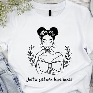 May include: Black and white illustration of a woman with flowers in her hair reading a book. The text "Just a girl who loves books" is below the image.
