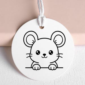 May include: A white, round tag with a black outline illustration of a cartoon mouse. The mouse has large ears, a small nose, and whiskers. A white string is attached at the top. The tag is likely for a gift or craft project.