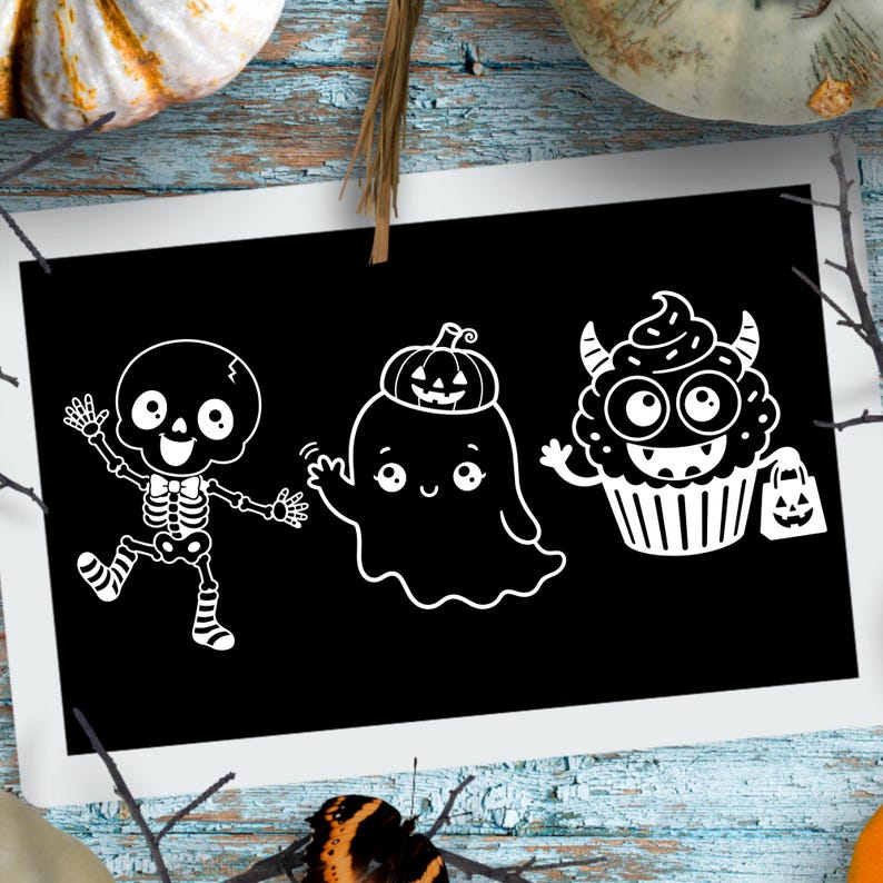May include: A rectangular black sign featuring three white line art illustrations: a dancing skeleton wearing striped socks, a ghost with a small pumpkin on its head, and a cupcake character with horns holding a small pumpkin treat bag.