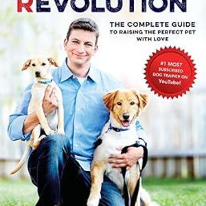 May include: A man with two dogs sits on the grass. The book cover reads "Zak George's Dog Training Revolution: The Complete Guide to Raising the Perfect Pet with Love." The cover also includes a red badge that says "#1 Most Subscribed Dog Trainer on YouTube!"