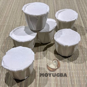 May include: Six white paper cups with a fluted design. The cups are stacked on top of each other and are arranged in a circle.