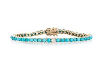 May include: A gold tennis bracelet with turquoise stones and a single diamond accent.