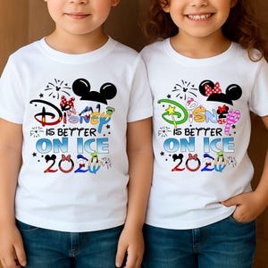 May include: Two white t-shirts with the text "Disney is Better on Ice 2020" in colorful lettering and graphics. The shirts feature Mickey and Minnie Mouse ears and fireworks.