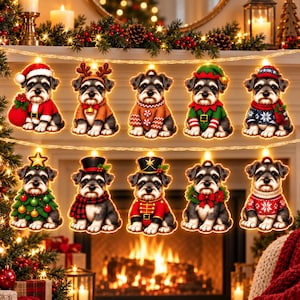 May include: A string of ten illuminated Christmas lights featuring Schnauzer puppies in various holiday costumes, including Santa, reindeer, elf, and nutcracker outfits, with each puppy figure glowing warmly against a festive fireplace background.