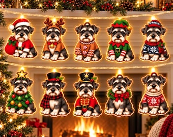 May include: A string of ten illuminated Christmas lights featuring Schnauzer puppies in various holiday costumes, including Santa, reindeer, elf, and nutcracker outfits, with each puppy figure glowing warmly against a festive fireplace background.