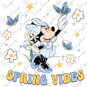 May include: A cartoon illustration of Minnie Mouse wearing a blue and white checkered dress and holding a bouquet of white flowers. She is standing on one foot and reaching up with the other hand to touch a blue butterfly. The background is white with a scattered pattern of blue butterflies, yellow stars, and white daisies. The text "SPRING VIBES" is written in large, colorful letters at the bottom of the image.