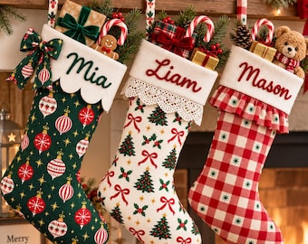 May include: Three Christmas stockings hanging in a row. The first is dark green with red and white ornaments, labeled Mia. The second is white with green trees and red bows, labeled Liam. The third is red and white gingham, labeled Mason.
