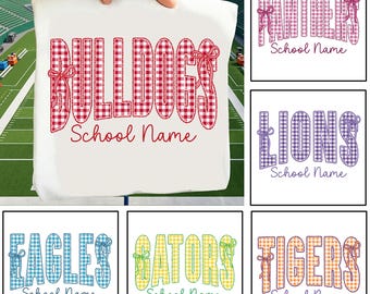 May include: A white fabric square featuring the red gingham text BULLDOGS with a bow accent and the words School Name in red script. Additional squares display the words PANTHERS, LIONS, EAGLES, GATORS, and TIGERS in various gingham colors.
