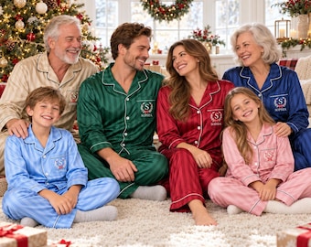 May include: A group of people wearing matching long-sleeved button-down pajama sets with white piping and a monogrammed crest on the chest pocket. The pajamas come in various colors including beige, green, red, blue, and pink, all featuring a subtle vertical striped pattern.