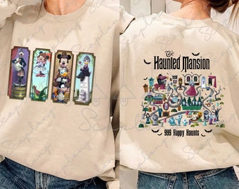 May include: A beige sweatshirt with a graphic print of the Haunted Mansion characters on the front and a map of the Haunted Mansion on the back. The text on the back reads "The Haunted Mansion 999 Happy Haunts".