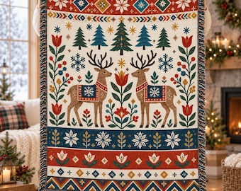May include: A woven throw blanket featuring a cream background with a repeating pattern of brown reindeer, green pine trees, red tulips, and blue snowflakes. The design includes horizontal bands of geometric shapes and floral motifs with fringe.