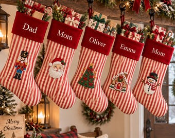 May include: Five red and white striped Christmas stockings with red velvet cuffs, each personalized with names Dad, Mom, Oliver, Emma, and Mom. The stockings feature embroidered holiday icons including a nutcracker, Santa, tree, house, and snowman.