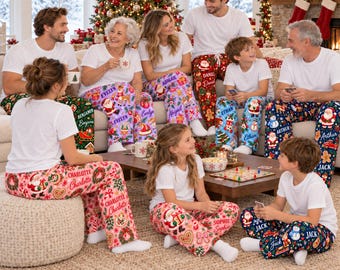 May include: A group of people wearing matching white t-shirts and personalized Christmas-themed pajama pants featuring various holiday prints like Santa Claus, gingerbread cookies, and wreaths, with each person's name printed on their pants.