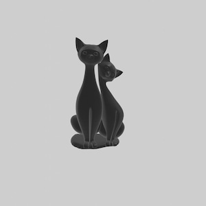 May include: Two black ceramic cat figurines sitting side by side. The cat on the left is looking straight ahead, while the cat on the right is looking to the left.