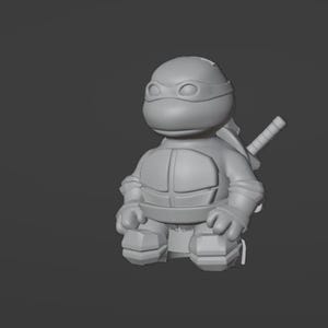 May include: A gray 3D-printed figurine of a Teenage Mutant Ninja Turtle. The figure is in a seated position, wearing a mask and carrying a katana on its back. The figure has a detailed design and is set against a gray background.