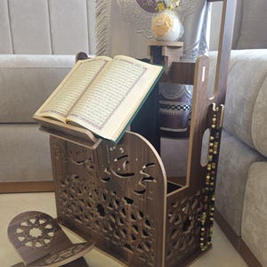 Moroccan Islamic prayer corner organizer in walnut brown — Quran stand, tasbih holder and prayer mat storage in one piece. Carved wood MDF with arabesque cutouts and Arabic calligraphy. Available in brown, beige and white. Islamic home decor handcrafted in Morocco.
