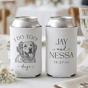 May include: Two white foam can coolers featuring black ink designs. The left cooler displays a golden retriever illustration with the text I DO TOO! and diego. The right cooler features the text JAY and NESSA with the date 12.27.xx.