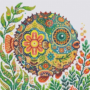 May include: A cross-stitch pattern featuring a round pufferfish decorated with intricate floral and geometric motifs in vibrant shades of yellow, teal, orange, and green, surrounded by aquatic plants and small bubbles on a white grid fabric.