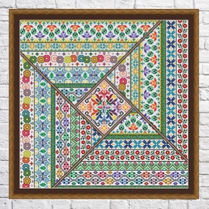 May include: A framed cross-stitch design featuring a colourful geometric pattern with various floral and geometric motifs. The design is framed in a brown wood frame with a white mount.