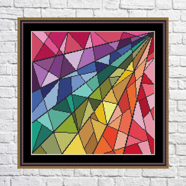 May include: A framed cross-stitch artwork featuring a geometric design with a spectrum of colors. The design includes triangles and other shapes in shades of red, orange, yellow, green, blue, and purple. The frame is brown with a gold inner edge.