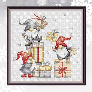 May include: Cross-stitch artwork featuring Christmas gnomes with gifts. The gnomes wear red and gray hats and coats, standing on stacks of wrapped presents. The presents are gold, red, and white, with bows. The background is white with star shapes.