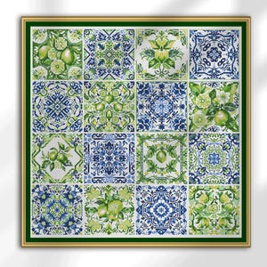 May include: A framed artwork featuring a grid of sixteen square tiles. Each tile displays a unique cross-stitch design in shades of green, blue, and white. The patterns include floral motifs, citrus fruits, and geometric shapes. The frame is gold with a green border.