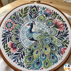 May include: A completed cross-stitch embroidery featuring a peacock design. The peacock is in the center, surrounded by a floral border. The color palette includes blues, greens, pinks, and white, all set within a wooden embroidery hoop.
