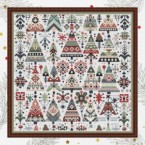 May include: A framed cross-stitch featuring a festive Christmas tree design. The artwork showcases a variety of stylized trees in red, green, and black, with intricate patterns and details. The piece is set against a white background and framed in a brown wooden frame.