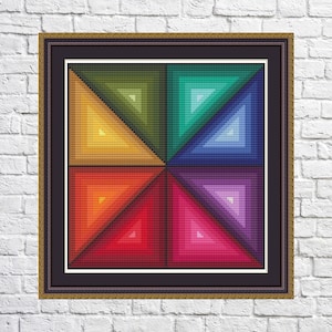 May include: A framed geometric art print with a colorful design. The print features a series of overlapping triangles in shades of green, blue, purple, red, and orange.