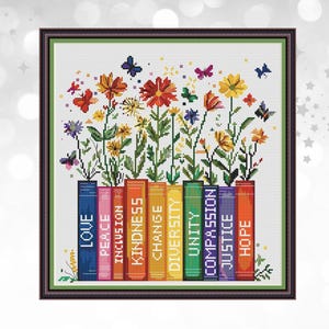 May include: Cross-stitch art featuring colorful flowers and butterflies emerging from a row of books. The books are labeled with words like "Love," "Peace," and "Hope." The artwork is framed in a dark brown frame.