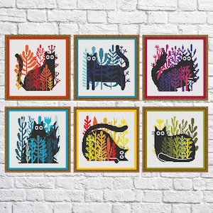 May include: Six cross-stitch patterns featuring black cats in colorful foliage. Each pattern is framed in a brown wood frame.