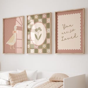 May include: Three framed prints with a pink and green color scheme. The prints feature a bird, a flower, and the text "You are so Loved".
