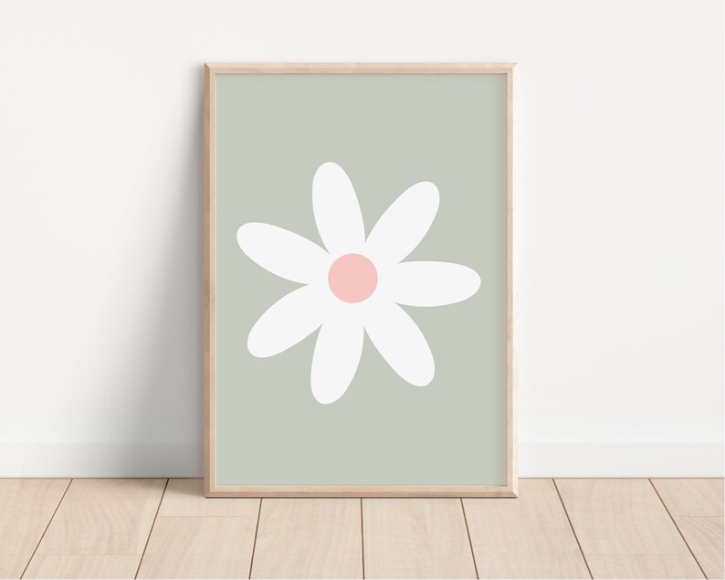 May include: A framed print of a white daisy with a pink center on a sage green background.