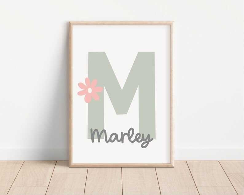 May include: A printable wall art design featuring a large, light green letter M with a pink flower and the name "Marley" written below.