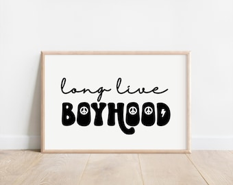 May include: A black and white print with the text "long live boyhood" in a retro font. The text is decorated with peace signs and a lightning bolt.