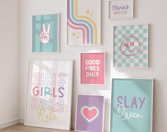 May include: A collection of framed wall art with various designs and text. The art pieces feature pastel colors, including pink, blue, and purple. Some pieces have text that reads "Girls Rule", "Good Vibes Only", and "Slay Queen".