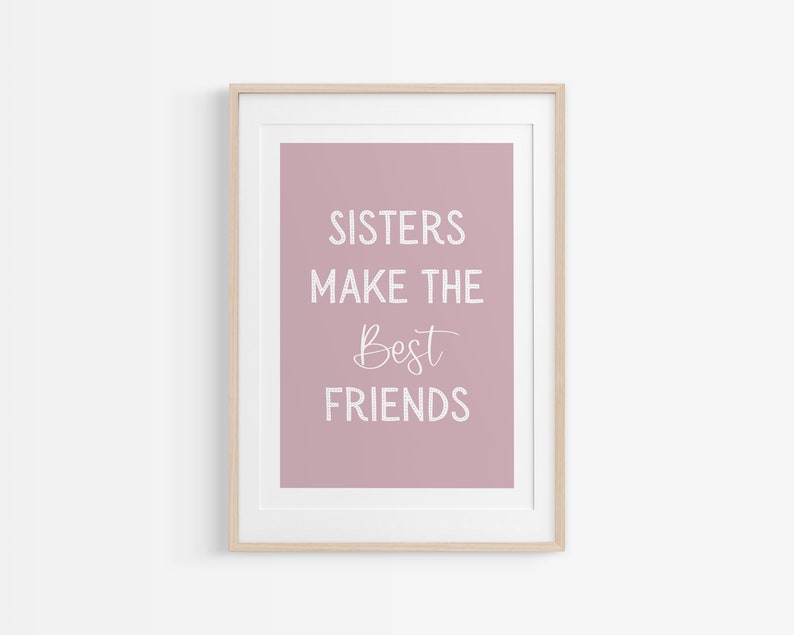 May include: A framed print with a pink background and white text that reads "Sisters make the best friends".