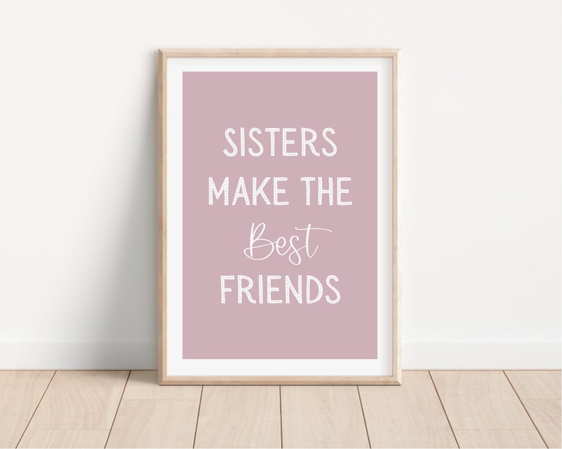 May include: A framed print with a pink background and white text that reads "Sisters make the best friends".