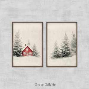 May include: A set of two framed watercolor paintings depicting a snowy winter scene with a red cabin and pine trees. The paintings are in brown frames and have a white background.