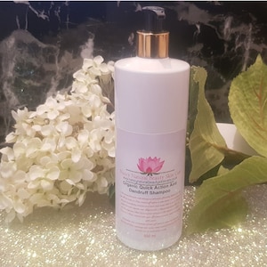 May include: A white bottle of Happy Natural Beauty Skin Care Organic Quick Action Anti Dandruff Shampoo with a gold pump top and a pink lotus flower logo. The bottle is 500 ml.