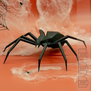 Peut inclure: Une araignée en papier noir avec huit pattes est posée sur un fond blanc et orange. L'araignée est faite de papier plié et a un design géométrique.