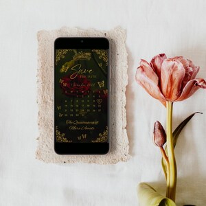 May include: A smartphone displaying a digital Save the Date calendar for November 2022, featuring a dark background with a red rose, gold butterfly accents, and the text The Quinceanera of Mara Amado, positioned next to a pink tulip.