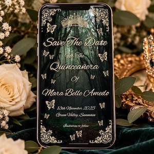 May include: A smartphone displaying a digital Save the Date invitation for the Quinceañera of Mara Belle Amedo on 13th November 2025 in Green Valley, Sunmain, featuring a dark forest background, gold butterfly accents, and a crown.