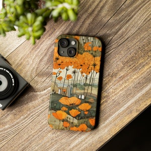 May include: A phone case with a floral design featuring orange flowers and a cityscape in the background.