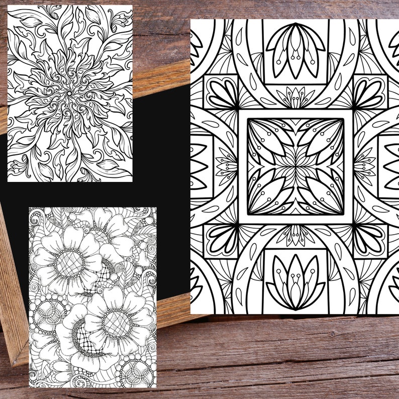 May include: Three black and white coloring pages featuring intricate floral and geometric designs. The pages are displayed on a wooden surface.