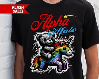 May include: Black t-shirt with a graphic of a teddy bear riding a rainbow unicorn. The text "Alpha Male" is written in red above the graphic.