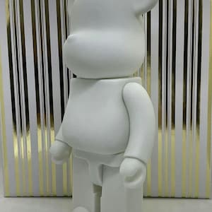 May include: A white blank bear figurine with a simple design. The bear is standing on a white surface.